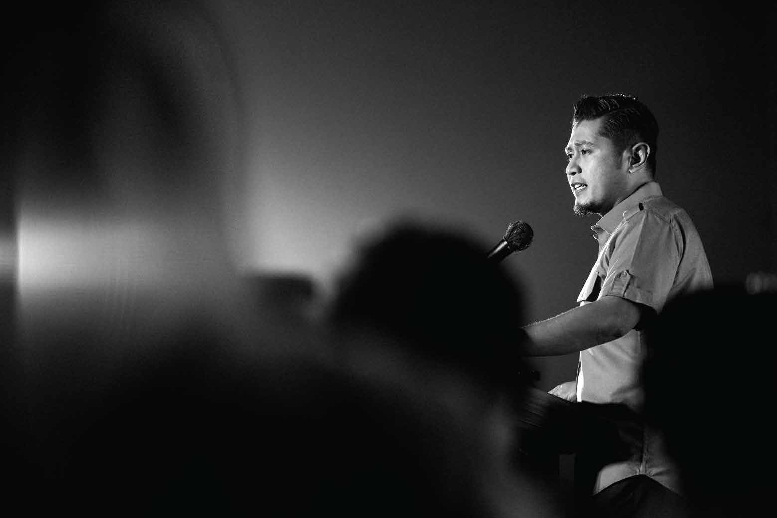 Speaker at a podium, black and white